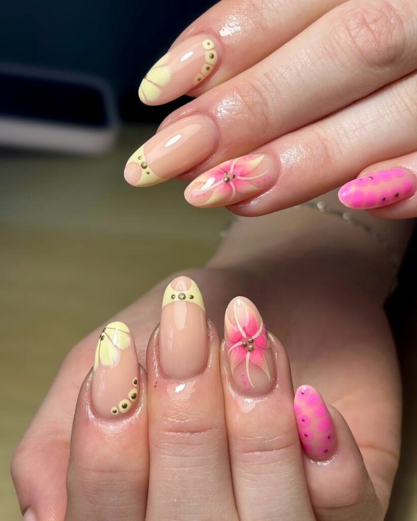 Almond Nail Ideas with Pastel Floral Tips and Gold Accents for a Whimsical Spring Look