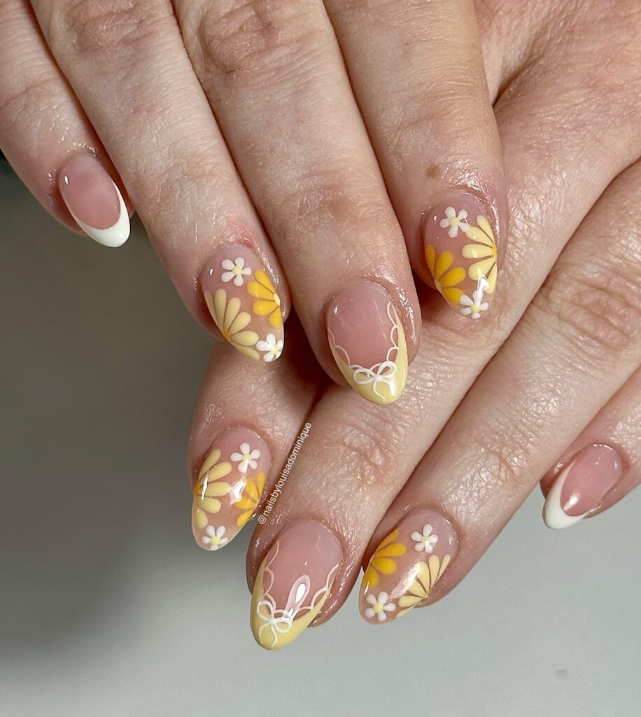 Almond Nails with Daisy Designs and Yellow French Tips for a Whimsical Spring Garden Look