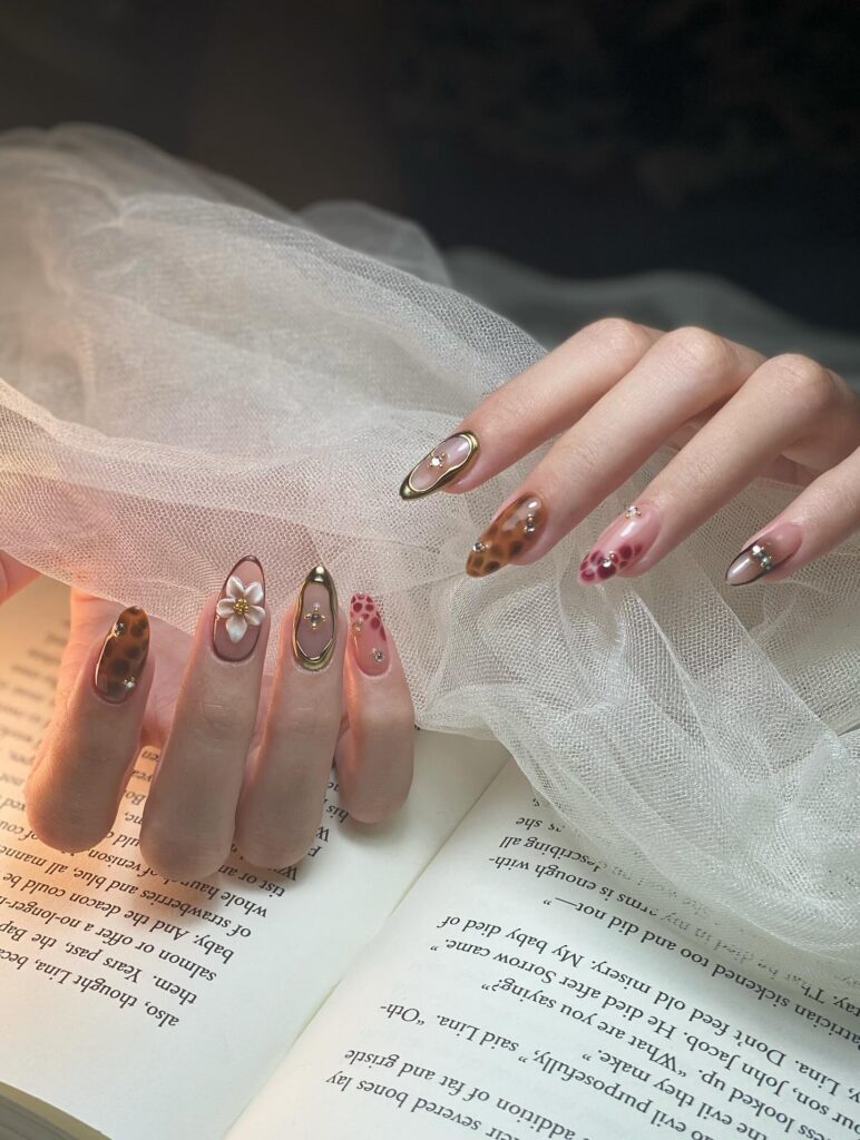 Almond Nails with Nude, Gold, and Leopard Art for a Luxe Summer Look