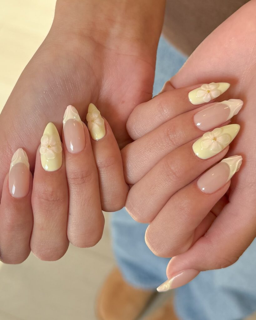 Almond Nails with Wavy Pastel Yellow Tips and 3D Floral Accents
