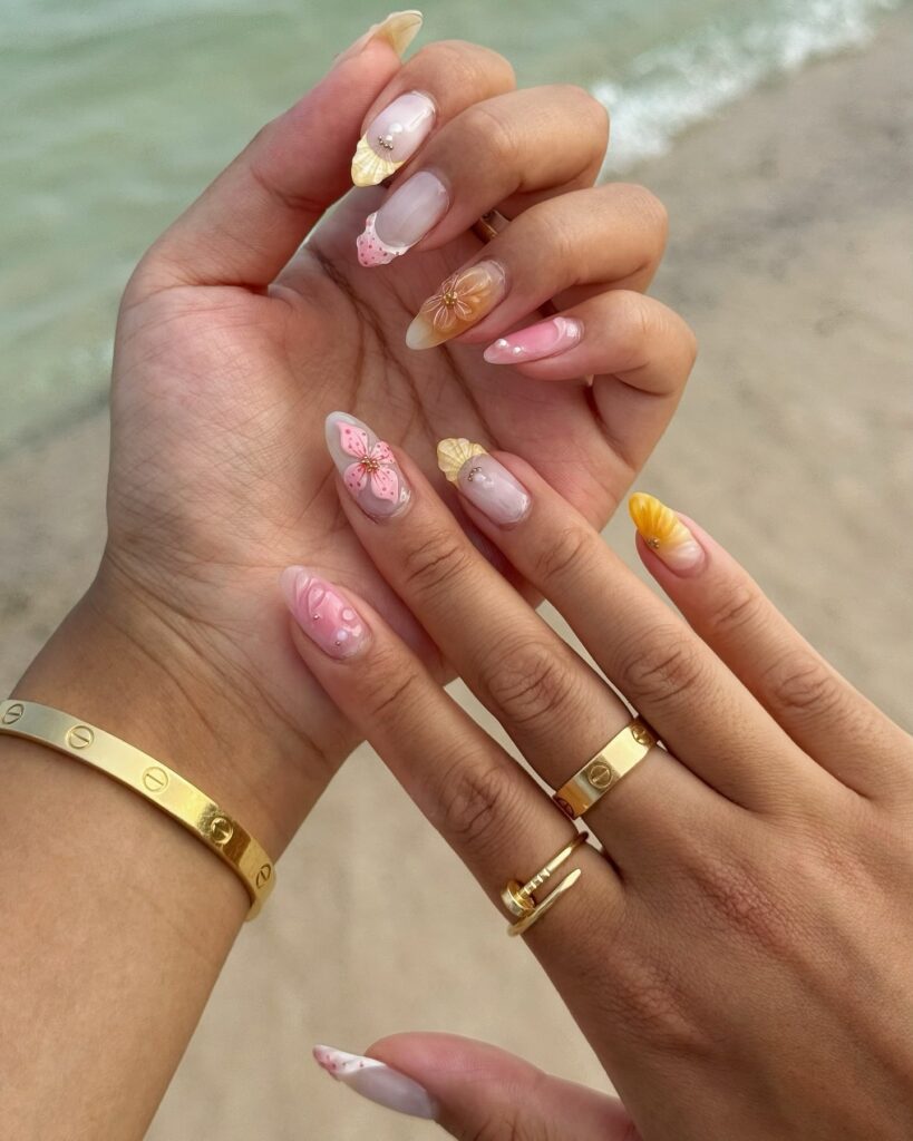 Almond Nude Nails with 3D Floral Art and Pearl Accents for a Romantic Beach Getaway