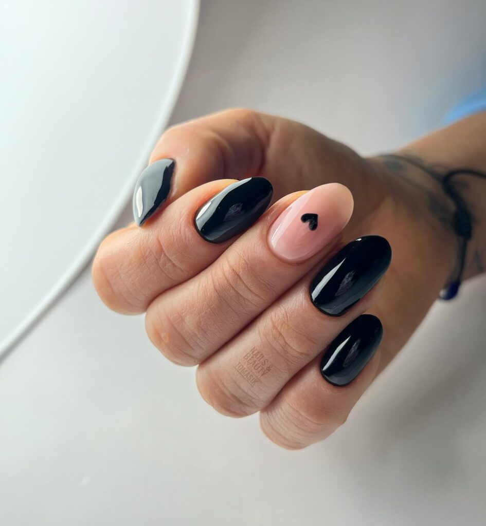 Almond Black Nails with Nude Accent and Minimal Heart Art