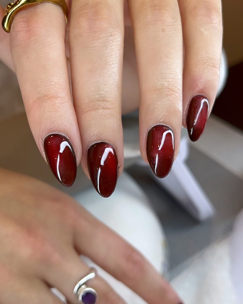 Almond Burgundy Nails with Subtle Shimmer and Glassy Finish