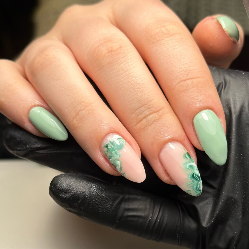 Almond mint green and blush pink marble nails with a glossy finish for a soft and artistic spring nail idea
