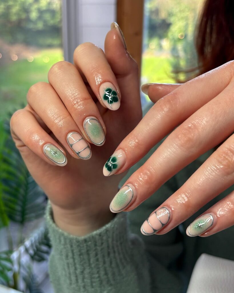 Almond Nude Nails with Clover Art and Green Shimmer for a Fresh Spring Look