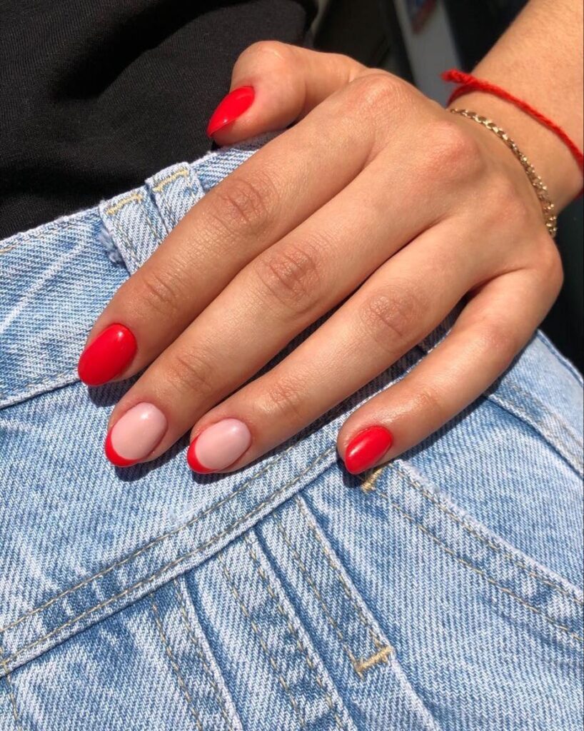 Almond-Shaped Red Nails with Reverse French Tips for a Trendy Everyday Look