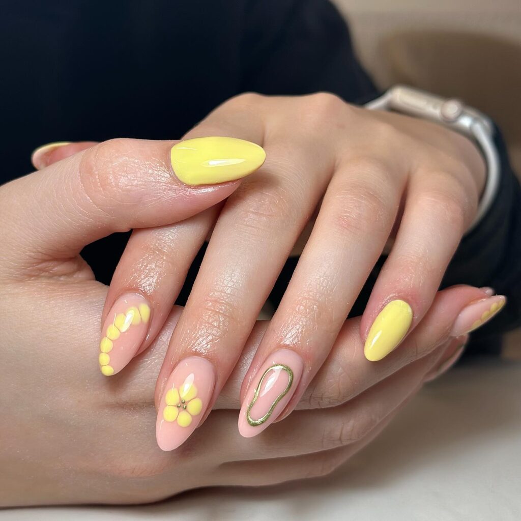 Artistic Pastel Yellow Almond Nails with 3D Flowers and Gold Abstract Accents