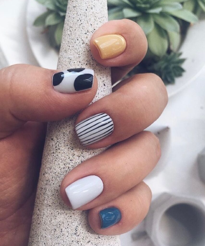 Artistic Short Square Nails with Mixed Patterns and Bold Colors
