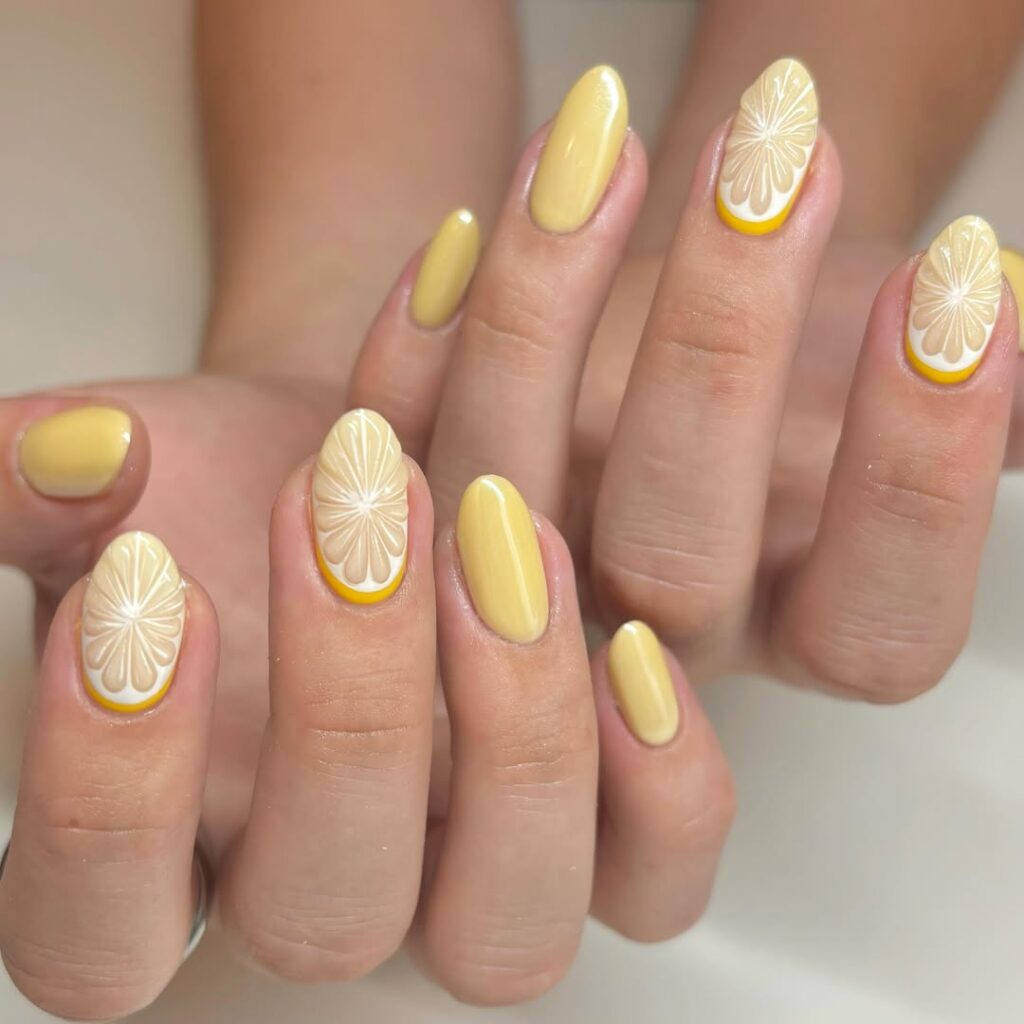 Buttery Yellow Almond Nails with Embossed Floral Texture for a Chic Retro Look