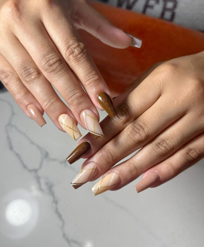 Coffin-Shaped Chocolate and Nude Nails with Geometric Gold Detailing for Summer-to-Fall Transition