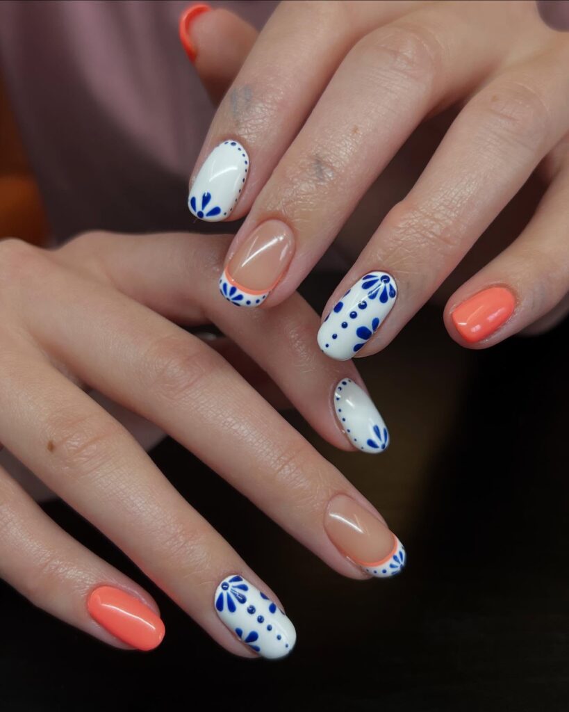 Coral and White Oval Nails with Blue Floral Art and French Accents