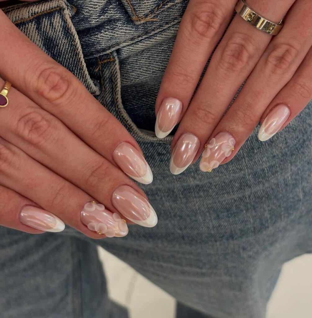 Elegant Almond Nude Pink Birthday Nails with Pearly White 3D Floral Accents and Modern Curved French Tips