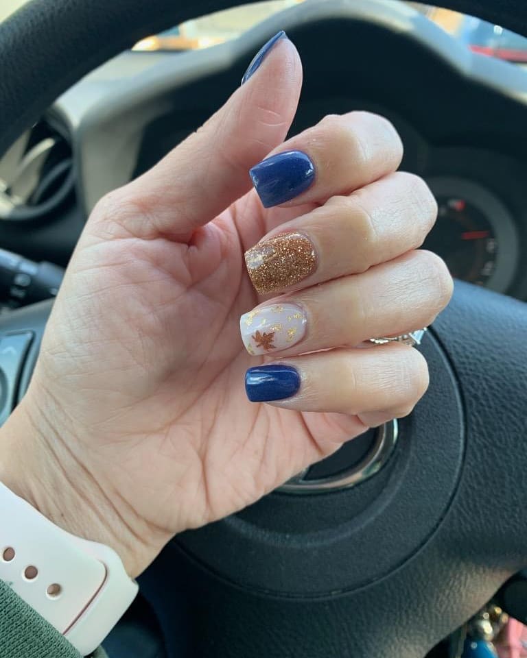 Fall Nail Ideas with Navy, Gold Glitter, and Maple Leaf Accents on Square Nails