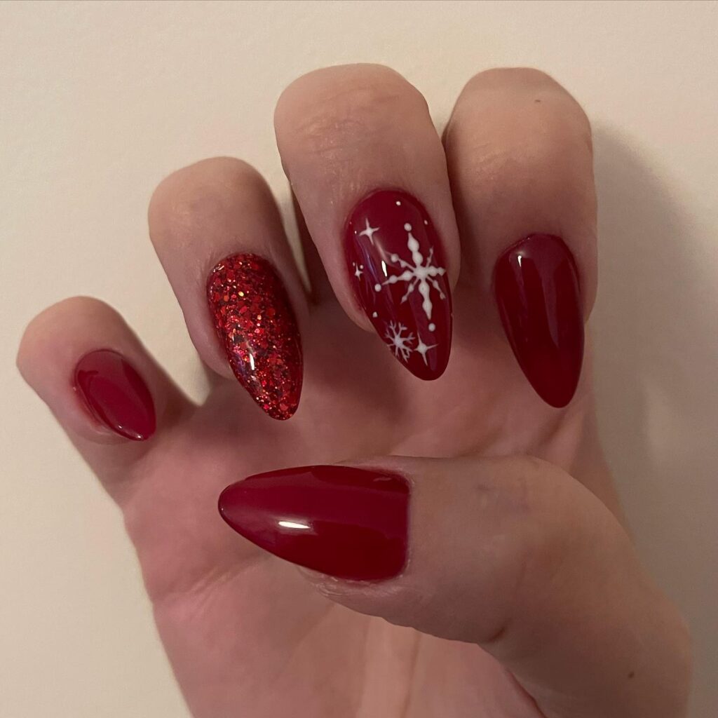 Festive Red Almond Nails with Glitter and Snowflake Nail Art