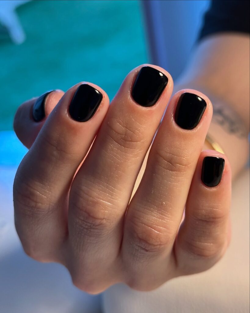 Glossy black short squoval nails timeless nail ideas with a bold and sleek finish