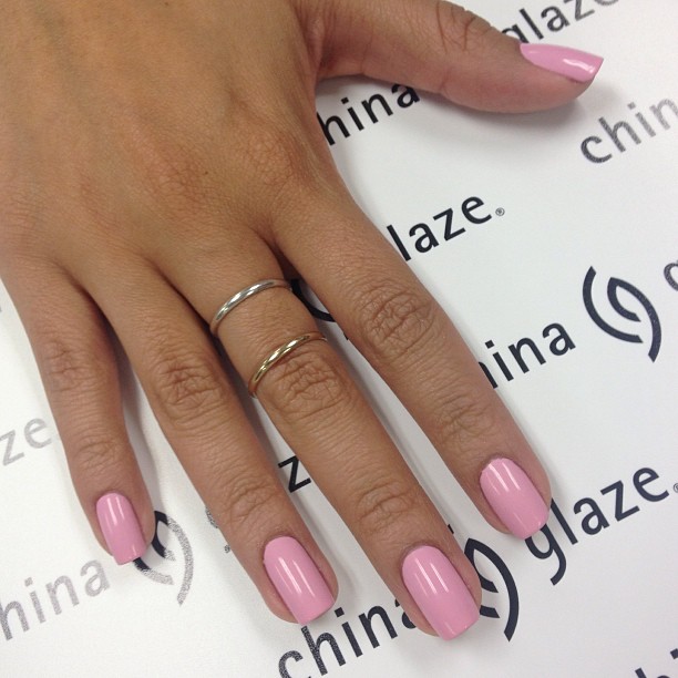 Glossy Bubblegum Pink Oval Nails Paired with Minimalist Rings for Playful Elegance