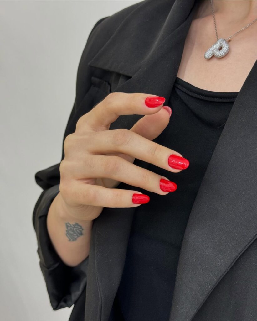 Glossy fire red round nails that add confidence and power to any outfit