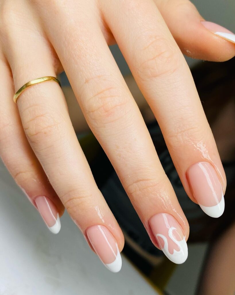 Glossy nude almond nails with French tips and heart drip for romantic nail ideas