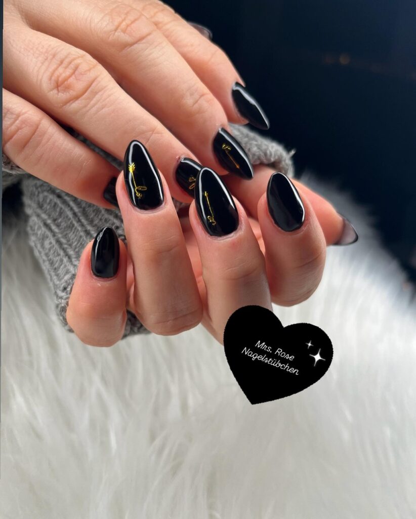 Gold-Accented Black Almond Nails with Glossy Luxury Finish