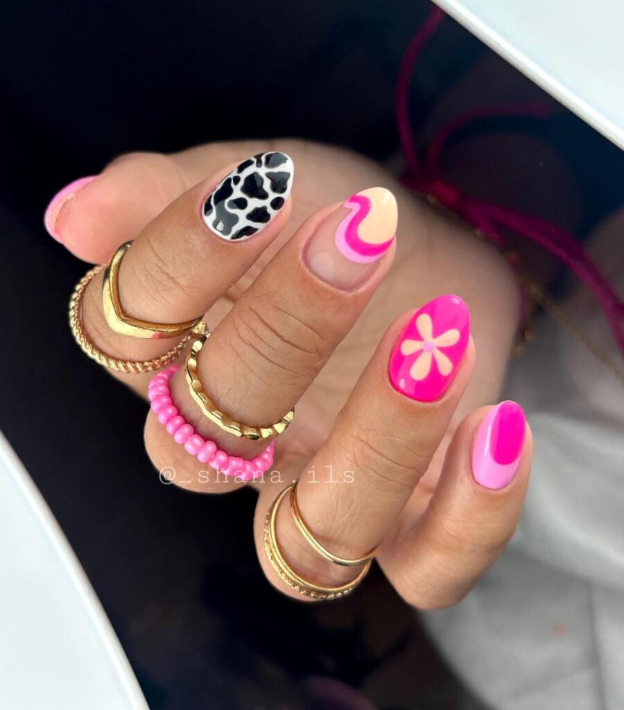 Hot Pink and Cow Print Almond Nails with Daisies and Swirls – Trendy Birthday Nail Ideas
