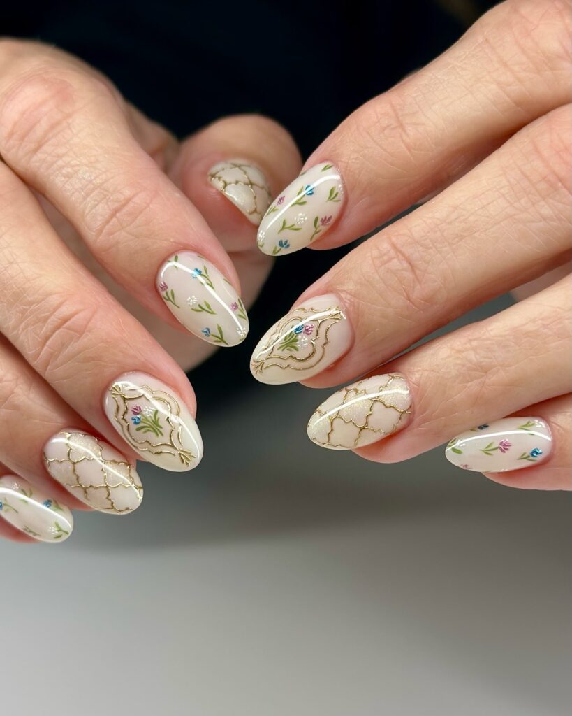 Ivory Almond Nails with Vintage Gold Frames and Floral Accents – Elegant Birthday Nail Ideas