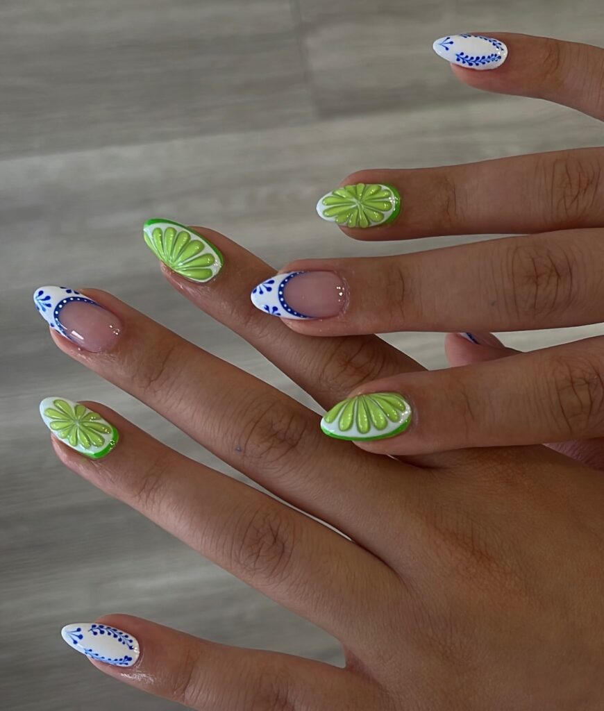 Juicy Fruit-Inspired Almond Nails with 3D Citrus Slices and Blue Floral Accents