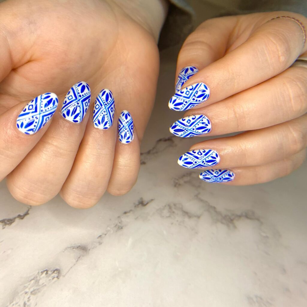 Mediterranean blue and white tile almond nails for elegant summer graduation nail ideas