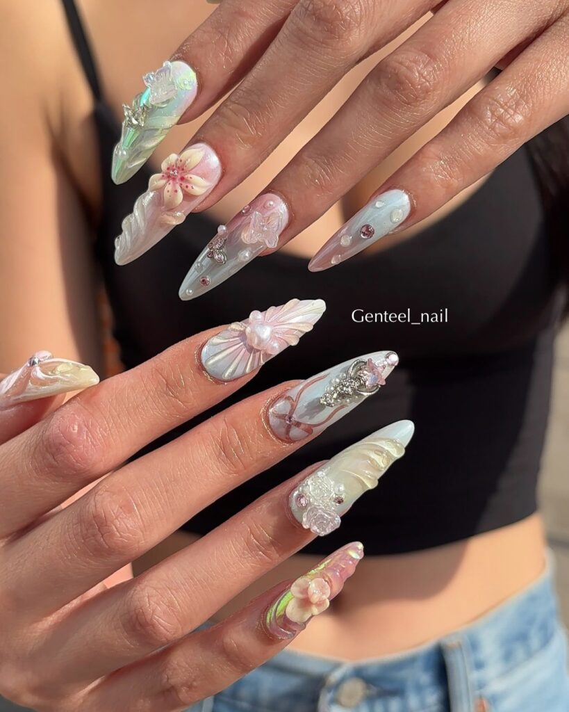 Mermaid Core Long Stiletto Nails with Iridescent Pastel Polish, Seashell Shapes, 3D Flowers, and Crystal Nail Art