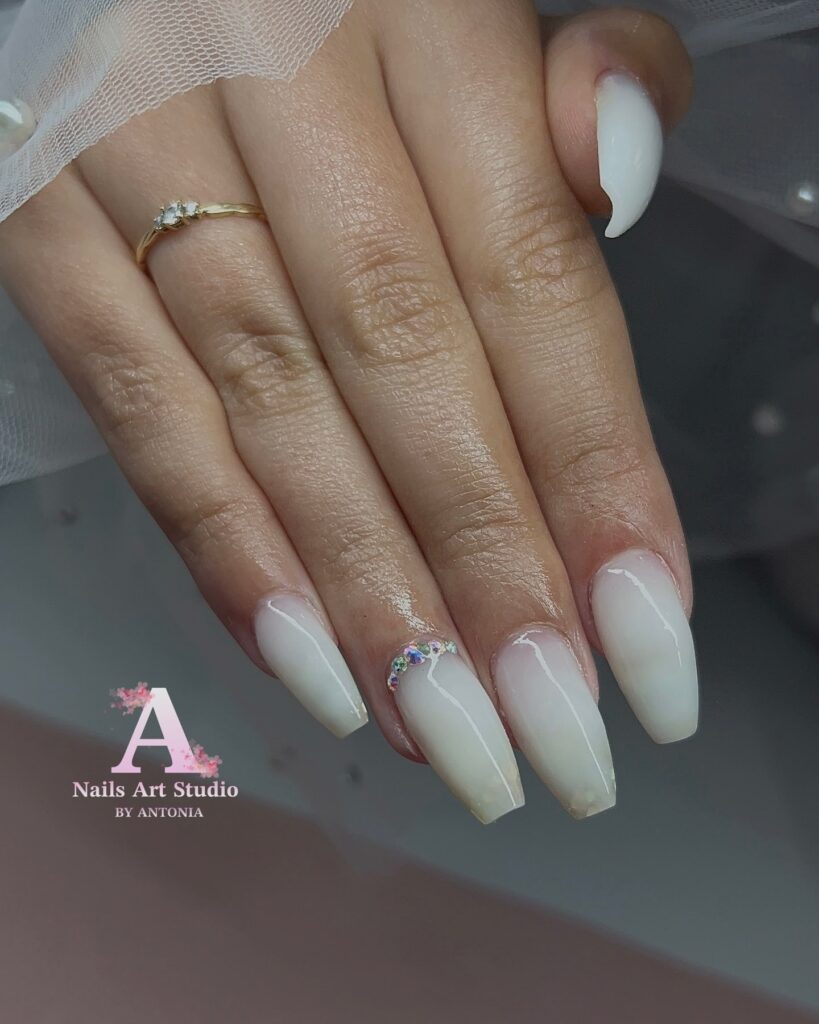 Milky white ombre coffin nails with rhinestone accents for elegant wedding nail ideas