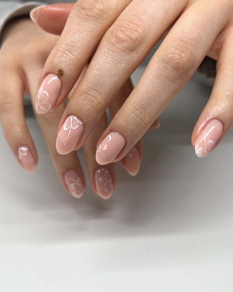 Minimal White Floral Line Art on Nude Almond Nails for Romantic Spring Nail Ideas