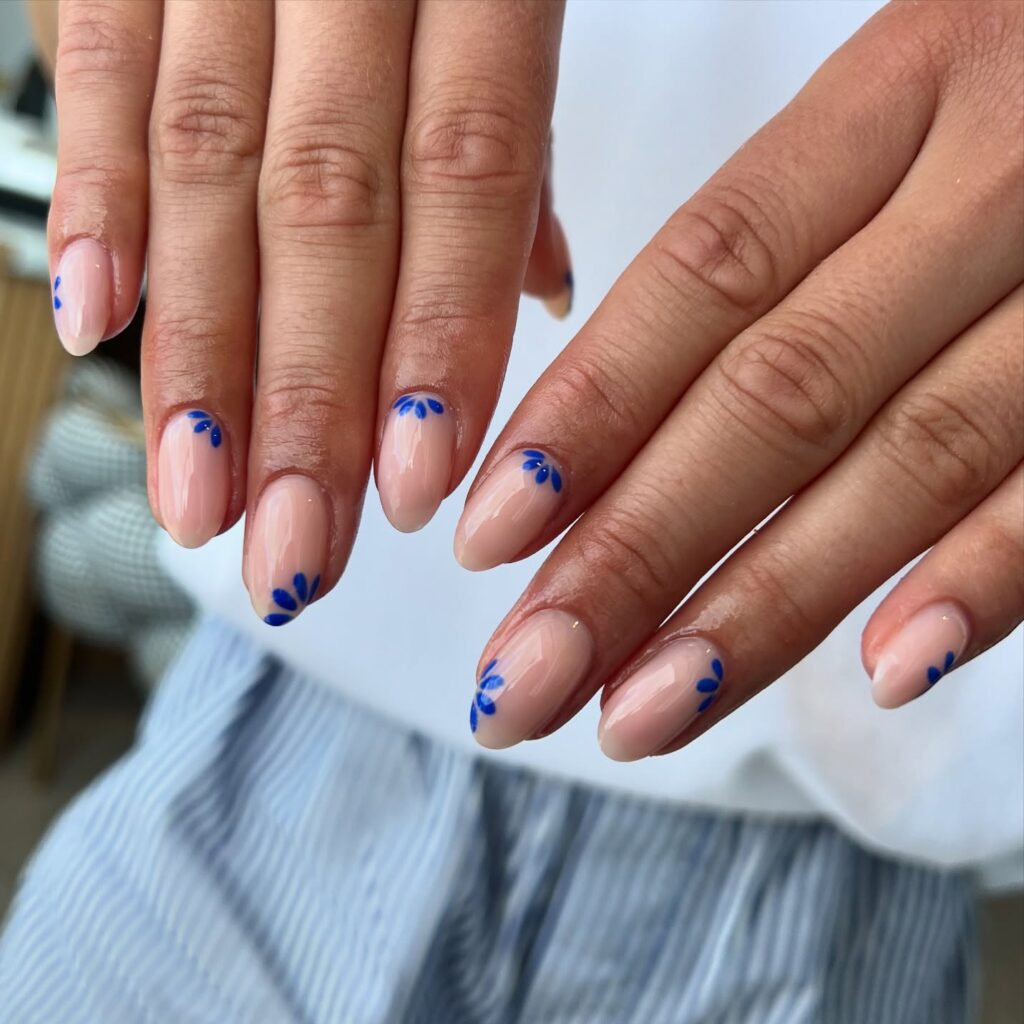 Minimalist Blue Floral Almond Nails on Nude Base – Elegant Spring and Summer Nail Ideas