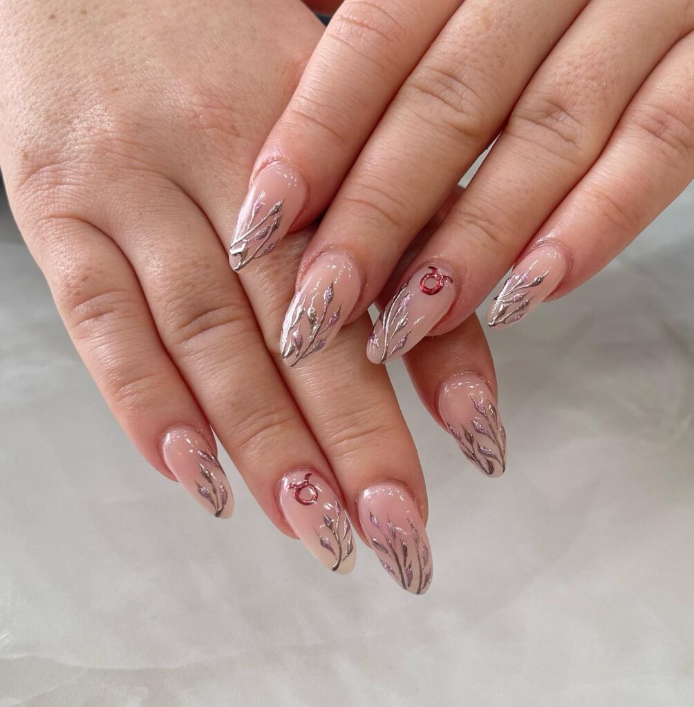 Minimalist Nude Nails with Metallic Leaves and Zodiac Accents