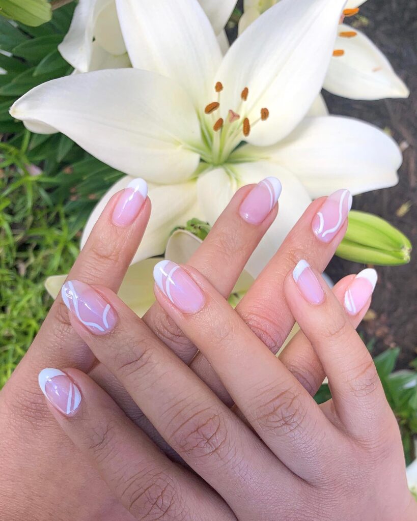 Minimalist White Swirl French Tips on Almond Nails – Sophisticated Spring Graduation Nail Ideas
