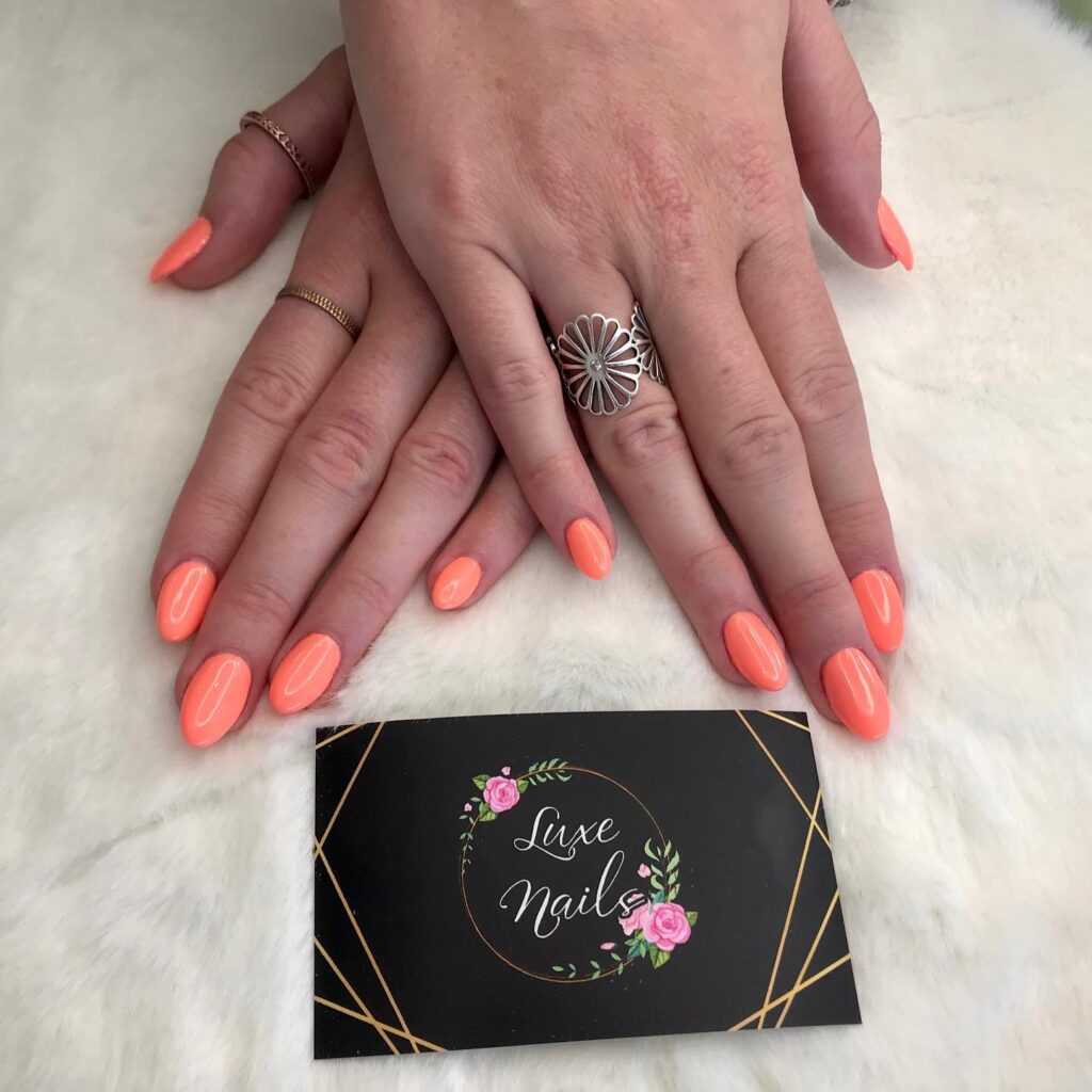 Neon Peach Almond Nail Ideas for a Bold, Glossy Summer Statement