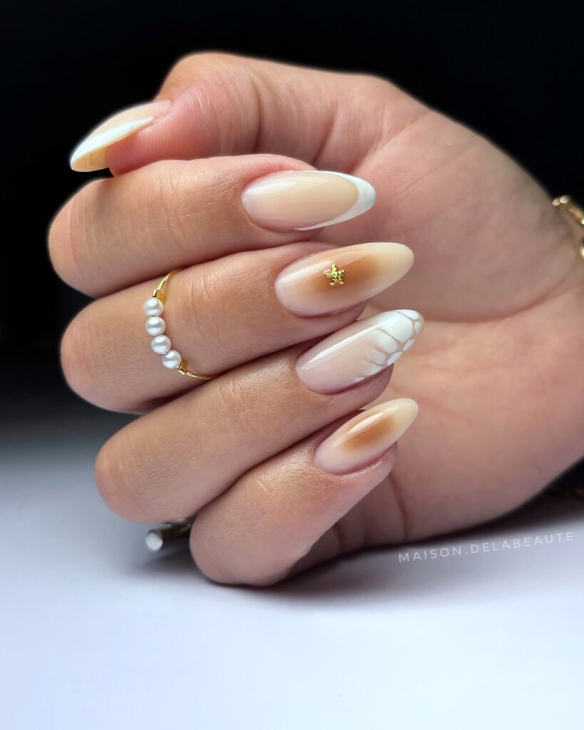 Neutral almond nails with white French tips and 3D cable knit detail for cozy fall style