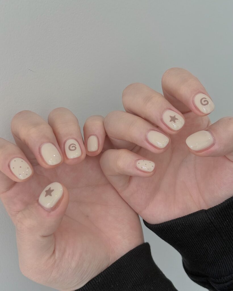 Neutral beige nails with brown accents minimalist nail art ideas for cozy vibes