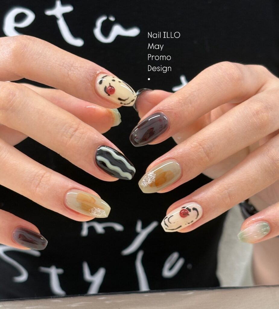 Oval nails with abstract face art and earthy tones like maroon olive and peach for a bold artistic look