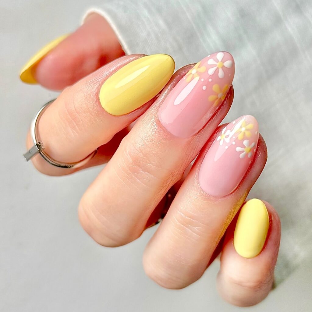 Pastel Pink and Yellow Almond Nails with Simple Daisy Accents