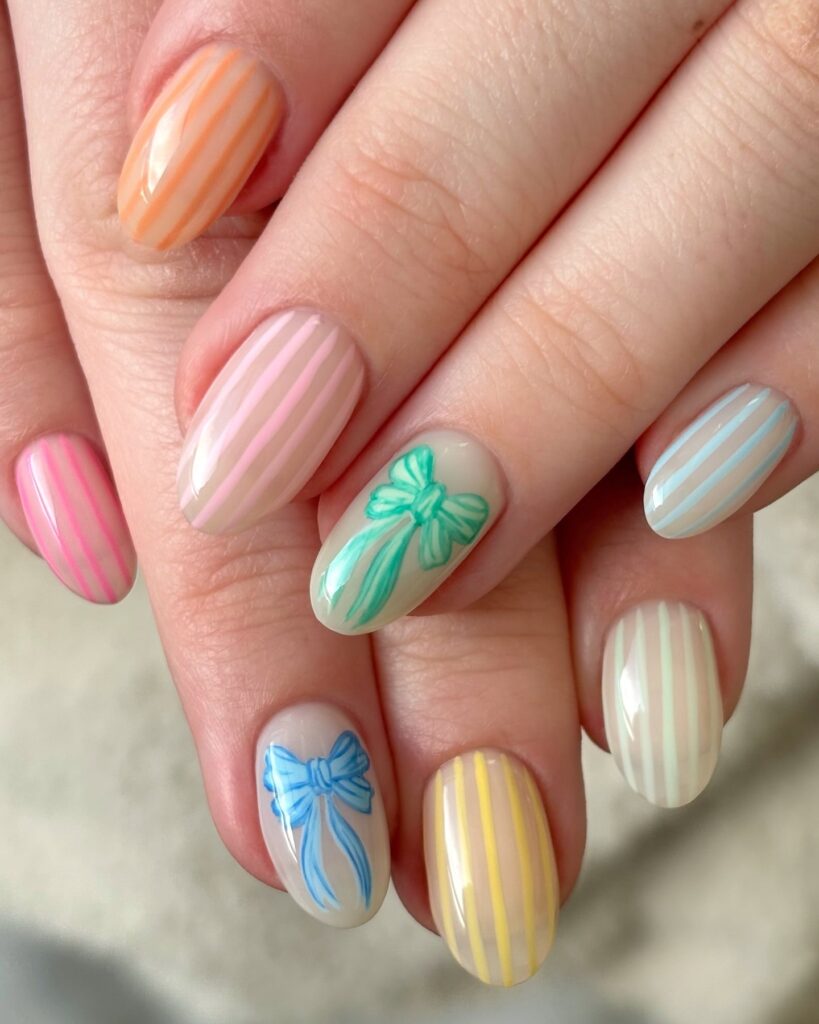 Pastel Candy Stripe Nails with Bows for a Whimsical Birthday Look
