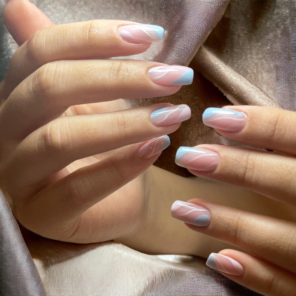 Pastel pink and blue square nails with flowing lines dreamy spring nail ideas