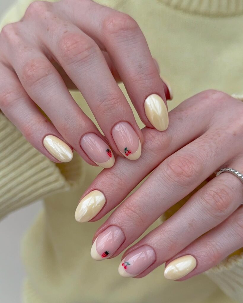 Pastel yellow almond nails with fruit art – fresh and sweet yellow nail ideas for spring