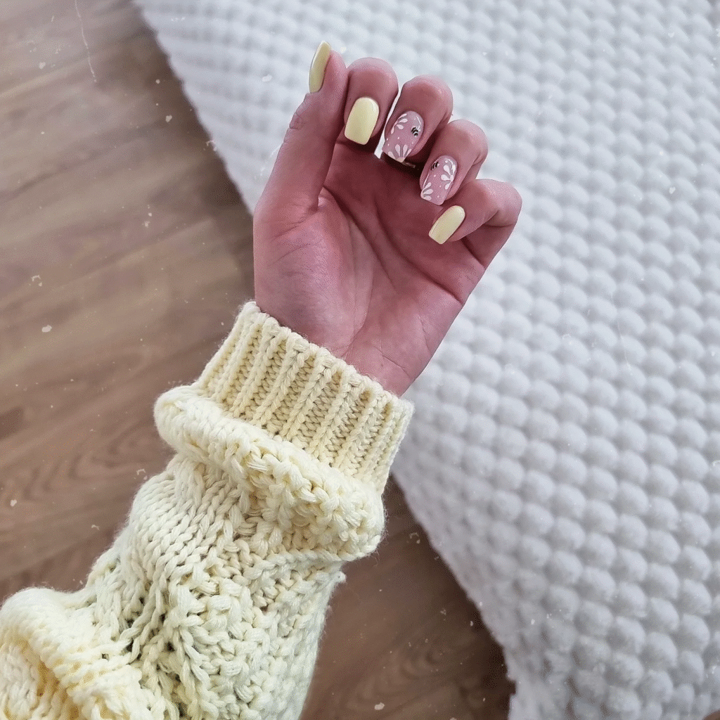 Pastel yellow and pink square nails with floral accents – cozy early spring yellow nail ideas