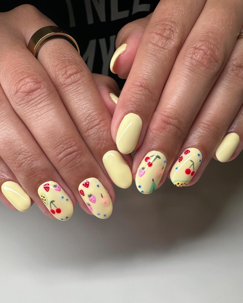 Pastel Yellow Oval Nails with Fruity Art – Playful Summer Nail Ideas
