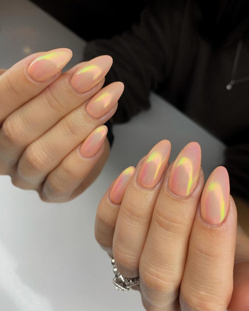 Peachy nude almond nails with iridescent chrome finish for modern luminous May nail ideas