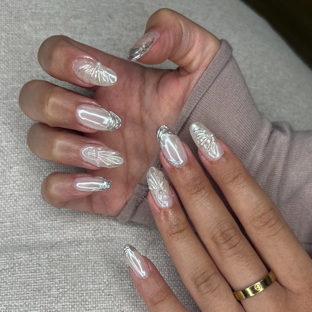 Pearlescent Almond Shell Nails with 3D Ocean-Inspired Accents and Pearls