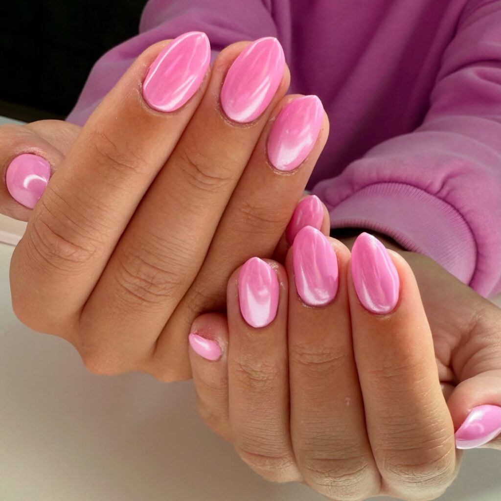 Pearlescent pink almond nails with marble effect for vibrant summer manicure