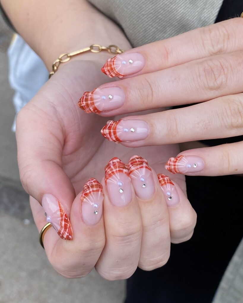 Plaid French Tips on Nude Almond Nails with Rhinestones for Playful Summer Style