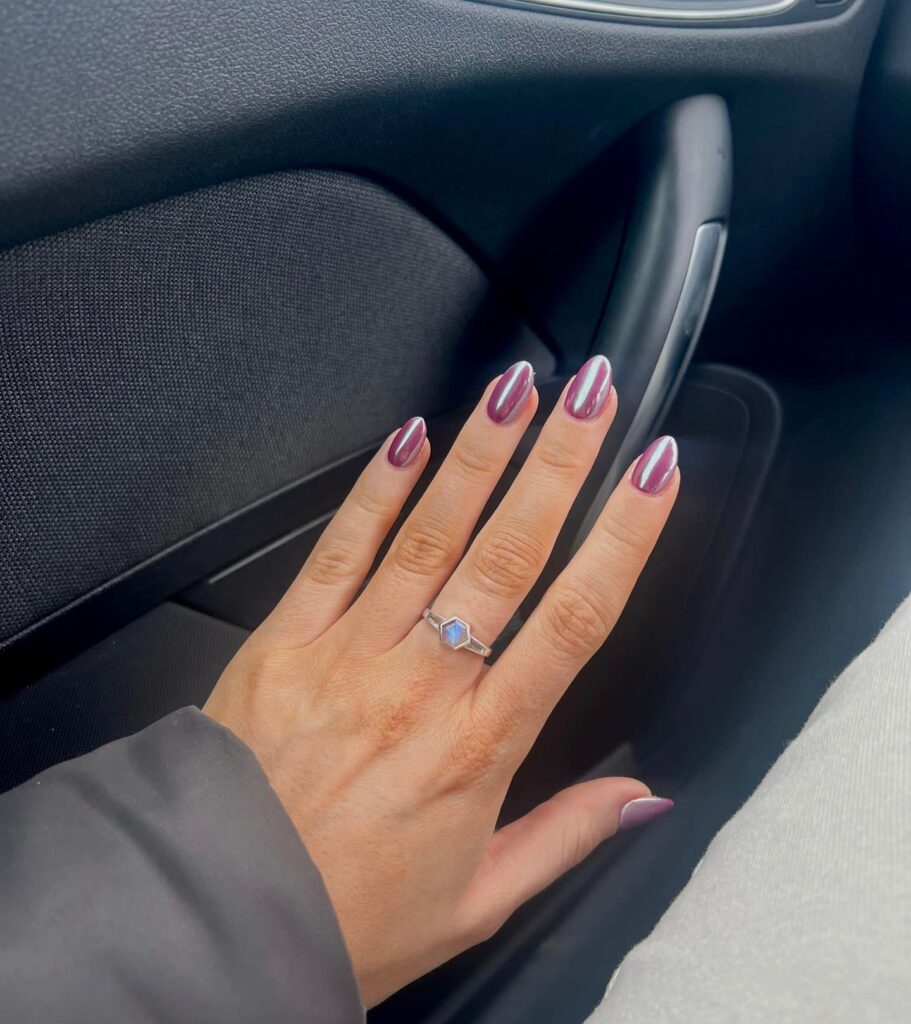 Plum purple almond nails with metallic chrome cat eye polish for a bold statement nail ideas