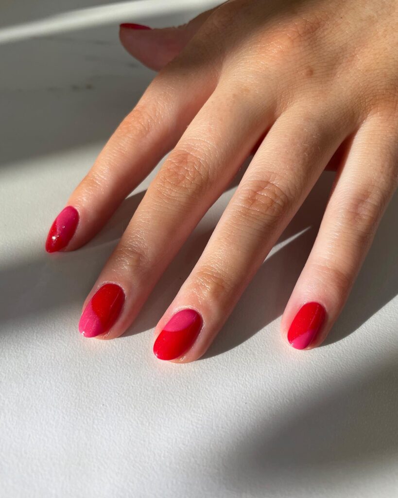 Red and hot pink oval nails bold color block nail ideas with playful energy