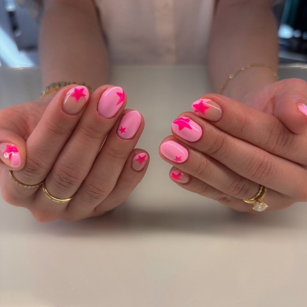 Rounded Short Baby Pink Birthday Nails with Hot Pink Star Designs for Playful and Fun Nail Art Ideas